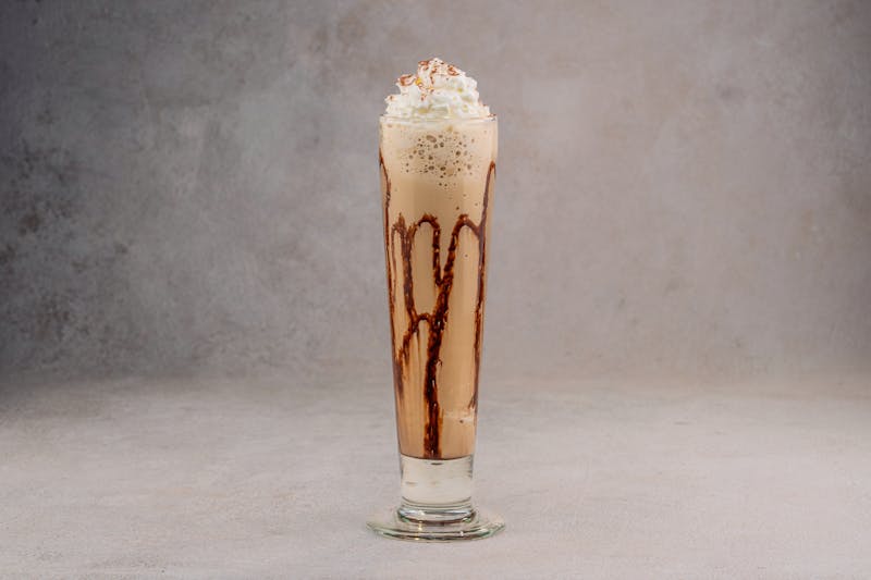 Thick creamy vanilla milkshake with whipped cream